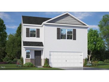Charming two-story home with a welcoming front yard and attached two-car garage at 409 Citron St, Sanford, NC 27332