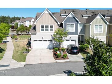 Charming townhome featuring attached garage, manicured landscaping, and a welcoming driveway at 4137 Strendal Dr, Cary, NC 27519