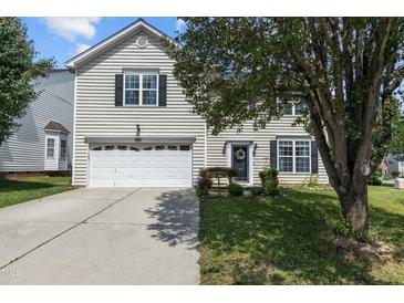 Charming two-story home with a well-manicured lawn and a classic garage at 6306 Winding Arch Dr, Durham, NC 27713