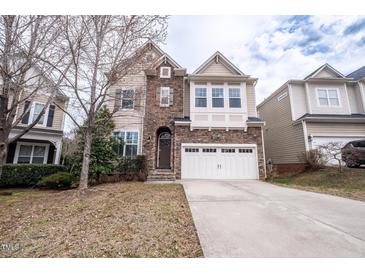 Beautiful two-story home with a stone facade and attached two-car garage at 804 Long Meadows Rd, Chapel Hill, NC 27516