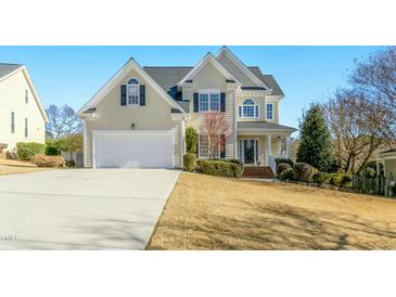 Charming two-story home with a well-manicured lawn and attached two-car garage at 1109 Frenchurch Way, Apex, NC 27502