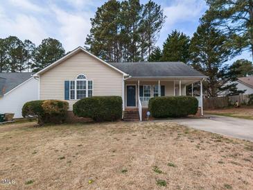 Charming single-story home with a well-maintained yard and inviting front porch at 212 Walnut Creek Dr, Clayton, NC 27520