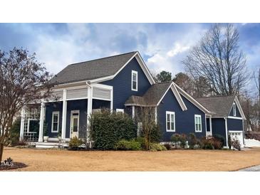 Charming navy-blue home with a welcoming front porch and beautifully landscaped yard at 27 Ellen Cir, Clayton, NC 27527
