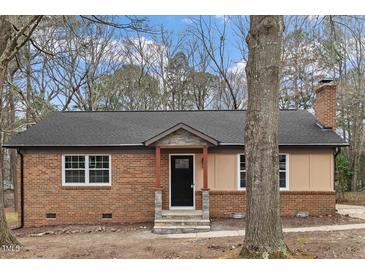 Charming brick home featuring a well-manicured lawn, inviting entrance, and an idyllic suburban setting at 7725 Longstreet Dr, Raleigh, NC 27615