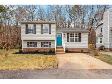 Charming two-story home with a bright blue front door and well-maintained front yard at 8341 Wynewood Ct, Raleigh, NC 27616
