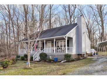 Charming single Gathering home boasts a cozy front porch, trimmed landscaping, and a welcoming atmosphere at 1008 Torredge Rd, Durham, NC 27712