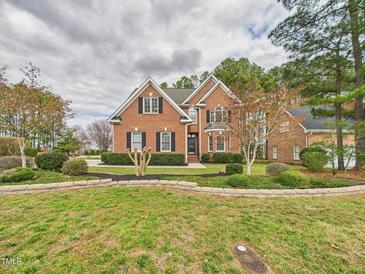 Charming brick home featuring a beautifully landscaped front yard and classic architectural details at 1201 Clematis St, Knightdale, NC 27545