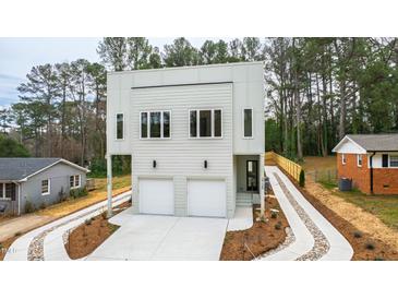 Beautiful two-story home with a modern design, two-car garage, and newly landscaped front yard at 2728 Milburnie Rd, Raleigh, NC 27610