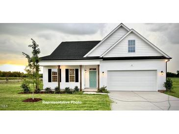 Charming new construction home featuring a lovely exterior, green lawn, black shutters and a two car garage at 37 Mossman Ct, Zebulon, NC 27597