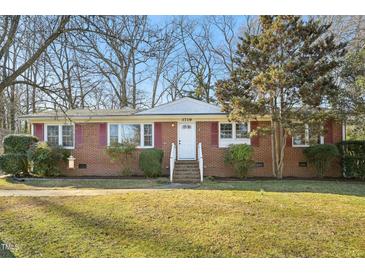 Charming brick home with red shutters and a well-manicured lawn at 3719 Hermine St, Durham, NC 27705
