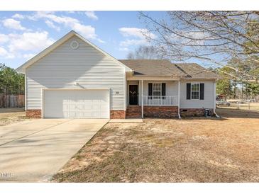Charming single-story home with a garage and well-maintained front yard at 38 Colonial Hills Dr, Lillington, NC 27546