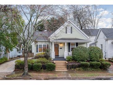 Charming home featuring a covered front porch, mature landscaping, and inviting curb appeal at 705 Hinsdale St, Raleigh, NC 27605