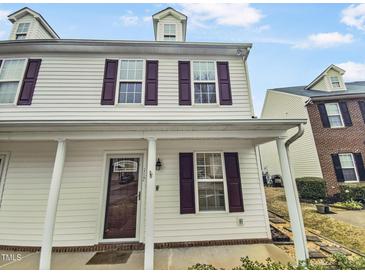 Charming two-story home with a covered porch, dormer, and attractive exterior siding at 117 Woodson Dr, Clayton, NC 27527