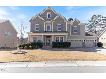 Inviting two-story home with a manicured lawn and a three-car garage, offering curb appeal and ample parking at 1922 Pattersons Mill Rd, Durham, NC 27703