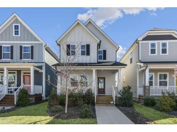 Charming two-story home with a welcoming front porch and well-manicured lawn at 237 Daniel Ridge Rd, Wendell, NC 27591