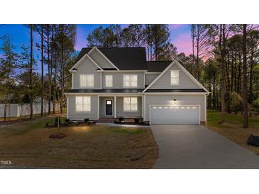 Charming two-story home with a well-maintained lawn and attached two-car garage at 25 Arbor Dr, Youngsville, NC 27596