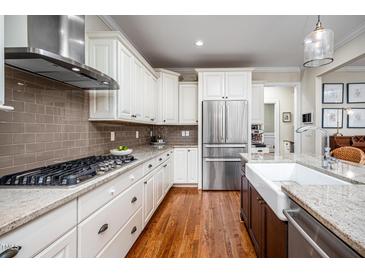 This kitchen features white cabinets, stainless steel appliances, and granite countertops at 260 Culbreth Rd, Chapel Hill, NC 27516