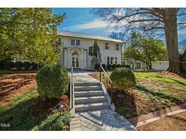 Beautiful two-story home with manicured landscaping, a metal roof, and a welcoming entrance at 330 Tenney Circle, Chapel Hill, NC 27514