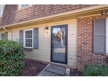 Charming home featuring a welcoming front door, brick accents, and tasteful shutters at 4705 Blue Bird Ct # C, Raleigh, NC 27606