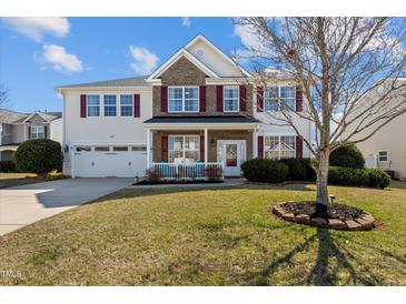Charming two-story home features a well-manicured lawn, red shutters and a two-car garage at 80 Ingle View Ct, Burlington, NC 27215
