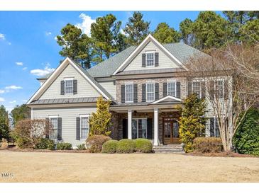 Beautiful two-story home featuring stone accents, a gabled roof, and a well-manicured front yard at 105 Jessfield Pl, Cary, NC 27519