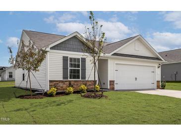Inviting single-Gathering home with an attached garage, manicured lawn and stone accents at 108 Hybrid St, Oxford, NC 27565