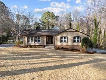 Charming single-story home featuring a well-manicured lawn and mature trees, and neutral paint scheme at 2108 Rangecrest Rd, Raleigh, NC 27612