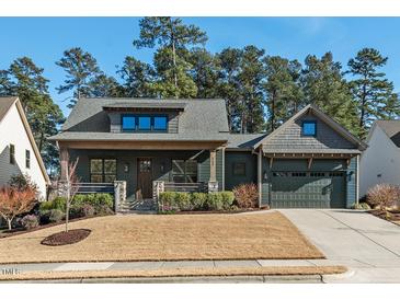 Charming home featuring a front porch, manicured lawn, and attached garage at 2128 Arborwood Dr, Durham, NC 27705