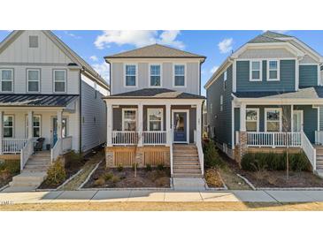 Charming two-story home features a welcoming front porch and neat landscaping in a friendly neighborhood setting at 283 Dry Canyon Dr, Wendell, NC 27591