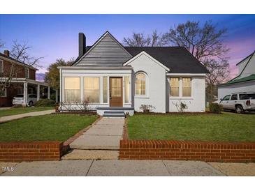 Charming home featuring a brick walkway and a well-maintained lawn in a traditional neighborhood at 512 S 4Th St, Smithfield, NC 27577