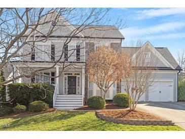 Charming gray two-story home featuring a landscaped front yard and two-car garage at 11342 Oakcroft Dr, Raleigh, NC 27614