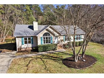 Charming single-story home with manicured lawn, mature trees, and inviting front entrance at 2204 Gentry Dr, Durham, NC 27705