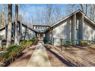 Charming home with mature landscaping and walkway leading to the front door at 3306 Whitfield Rd, Chapel Hill, NC 27514