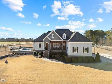 Beautiful home with a manicured lawn, mature trees, and an in-ground pool at 3805 Barberry Lake Ct, Fuquay Varina, NC 27526