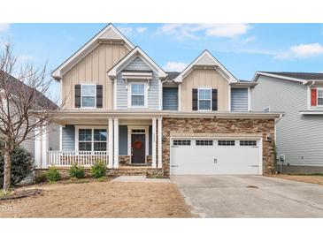 Charming two-story home with stone accents, covered porch, and a two-car garage at 8008 Hergety Dr, Raleigh, NC 27603