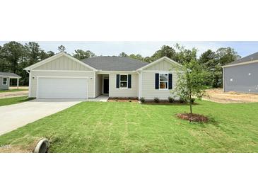 Charming single story home with a 1 car garage, well kept lawn and landscaping at 158 Gobbler Dr, Smithfield, NC 27577