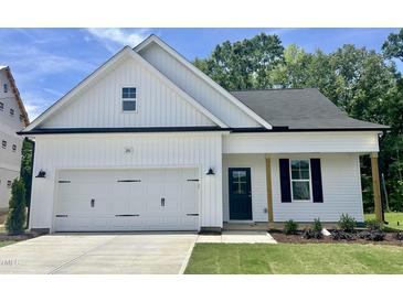 Charming single-Gathering home featuring a two-car garage, dark shutters and door, and a well-manicured lawn at 201 W Saltgrass Ln, Smithfield, NC 27577