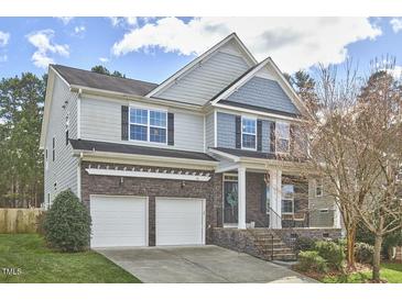 Charming two-story home with a two-car garage and stone accents on the lower level at 215 Strolling Way, Durham, NC 27707