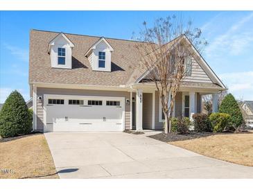 Charming home featuring a two-car garage, dormers, and manicured front yard landscaping at 345 Springtime Fields Ln, Wake Forest, NC 27587