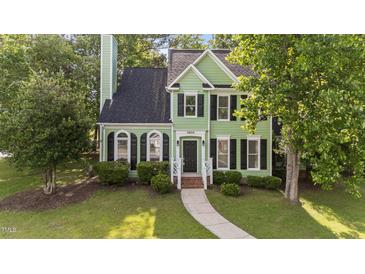 Charming two-story home with green siding, black shutters, and a well-manicured front yard at 3624 Singleleaf Ln, Raleigh, NC 27616