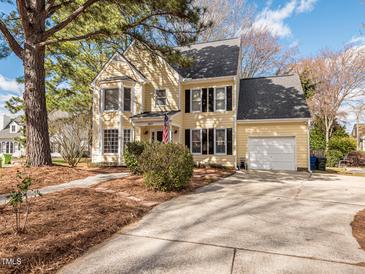 Charming yellow two-story home with a well-maintained front yard and attached garage at 4617 Atterbury Ct, Raleigh, NC 27604