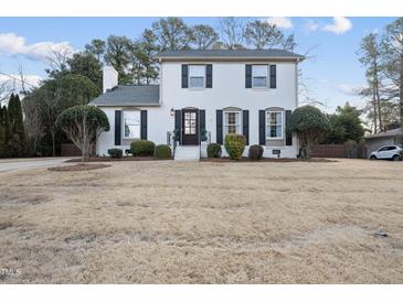 Charming two-story white brick home featuring manicured landscaping and a welcoming entrance at 4708 Sweetbriar Dr, Raleigh, NC 27609