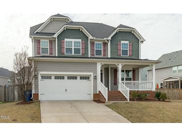 Charming two-story home with a covered front porch and two-car garage at 4821 Heathshire Dr, Raleigh, NC 27616