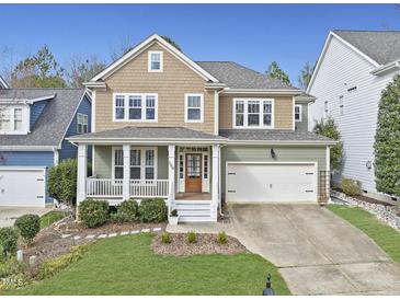 Charming two-story home featuring a welcoming front porch and attached two-car garage at 500 Skygrove Dr, Holly Springs, NC 27540