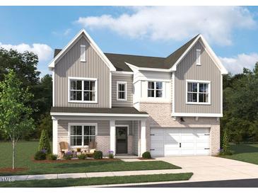 Charming two-story home with brick accents, gray siding, an attached garage, and a welcoming front porch at 544 Jocund St # 16, Rolesville, NC 27571
