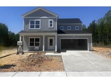 Charming two-story home with gray siding, black roof, inviting front porch, and attached garage at 564 Jocund St # 11, Rolesville, NC 27571