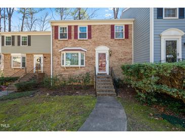 Charming brick townhouse with red shutters and a well-manicured front yard at 706 Collington Dr, Cary, NC 27511