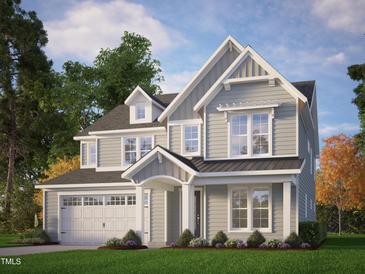Charming two-story home with gray siding, white trim, and a well-manicured lawn surrounded by mature trees at 9168 Dupree Meadow Dr # 15, Angier, NC 27501