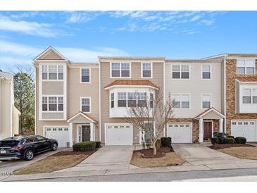Charming multi-level townhomes with attached garages, manicured lawns, and inviting curb appeal at 110 Darley Dale Loop, Apex, NC 27502