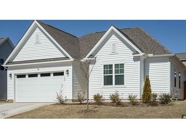 Charming, single-story home with white siding, attached two-car garage, and manicured lawn at 120 Wise Oak Ln, Garner, NC 27529